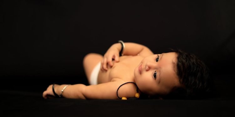 A baby in a dark surround