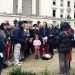Large group of people standing on a pavement