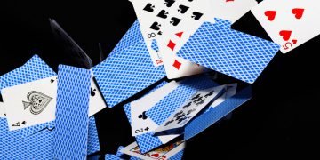 playing cards falling, like a collapsing house of cards