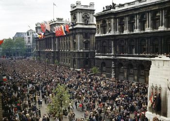 View of the crowd in the street by the London Cenotaph, celebrating VE day