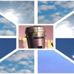 Man with a bin on his head: Count Binface, and picture of the sky around him.