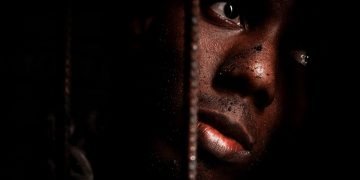Man with dirt on his face and looks scared